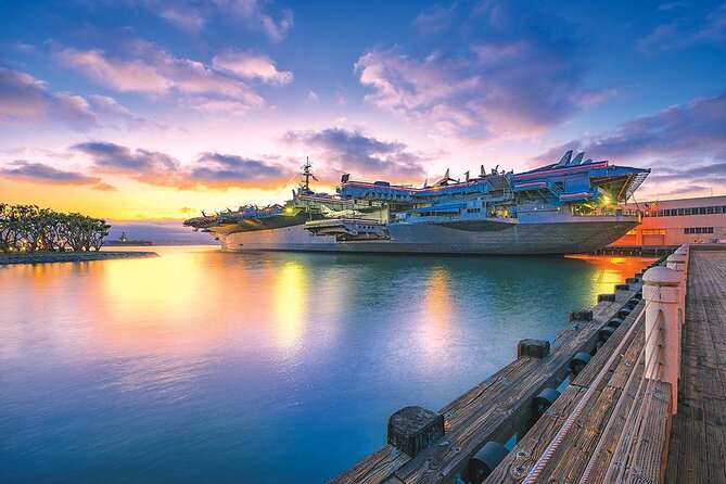 Sunset over San Diego Bay with the downtown skyline behind the moored fleet